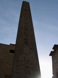 Low angle view of cross against sky