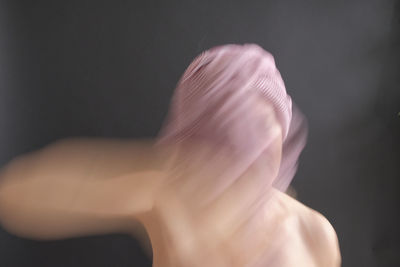 Rear view of man against black background