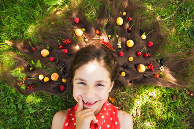 Portrait of a smiling young woman lying on grass