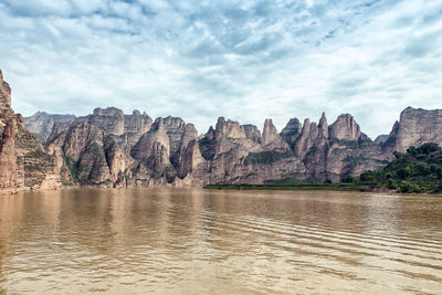 Scenic view of lake and mountains against sky