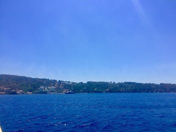 Scenic view of sea against clear blue sky