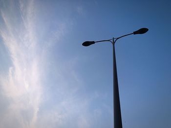 Low angle view of street light against blue sky