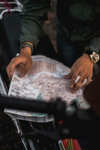 High angle view of man holding hands on table