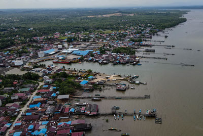 High angle view of crowd by sea against buildings in city