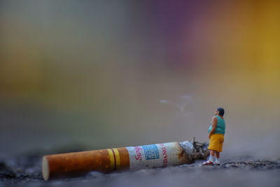 Close-up of cigarette in bottle against blurred background