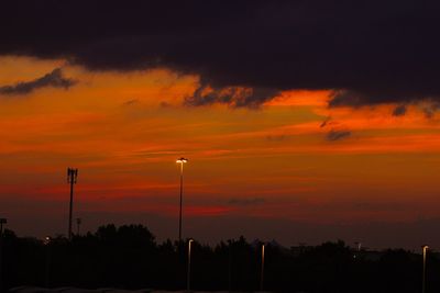 Low angle view of silhouette trees against sky at sunset