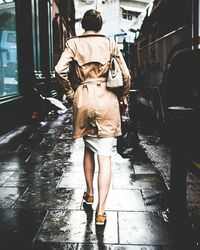 Full length of woman standing by railing