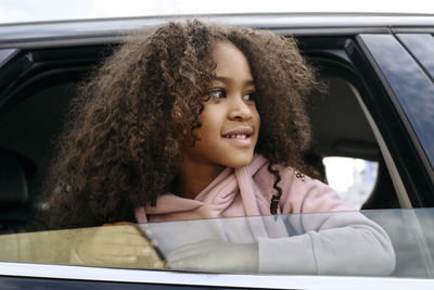 Portrait of a girl sitting in car