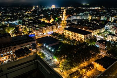 High angle view of illuminated cityscape against sky at night