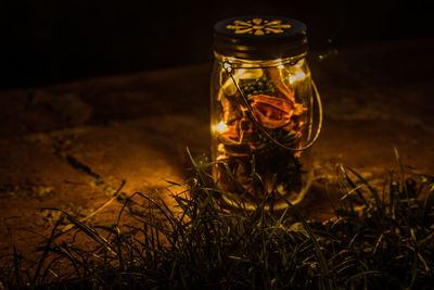 Close-up of glass jar on grass