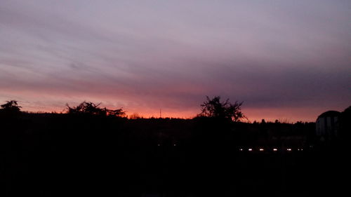 Silhouette trees against sky during sunset