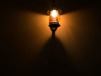 Close-up of illuminated light bulb in darkroom