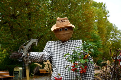 Rear view of woman standing against trees