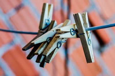 Low angle view of clothespins hanging on clothesline