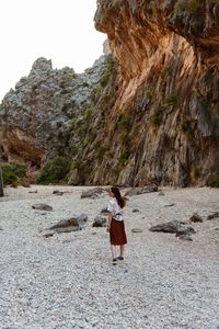 Rear view of woman walking on rock