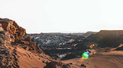 Scenic view of landscape in desert against clear sky