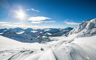 Scenic view of snow covered mountains against sky