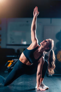 Young woman exercising in gym