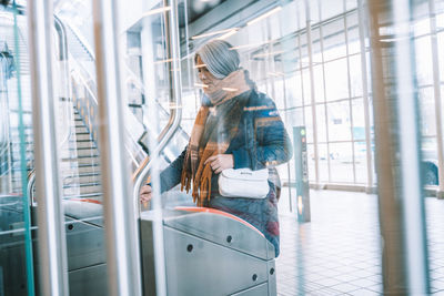 Mature woman standing at railroad station