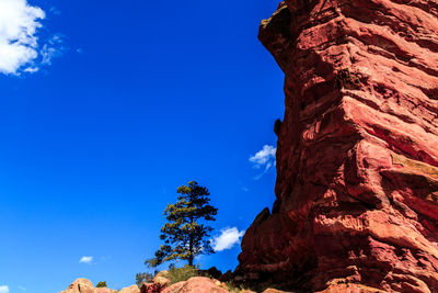 Low angle view of rock formation against blue sky