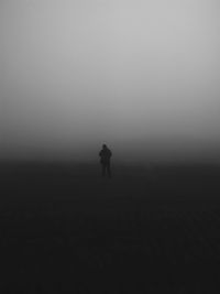 Silhouette person standing on field against sky