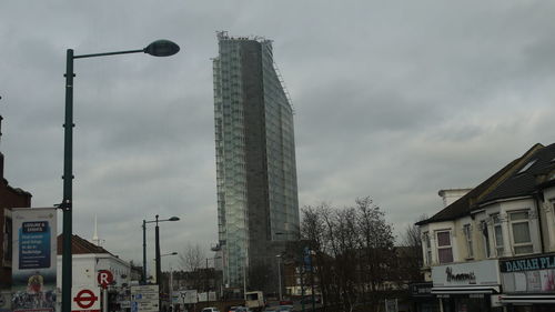 Low angle view of building against cloudy sky