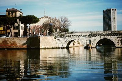 Bridge over river with buildings in background