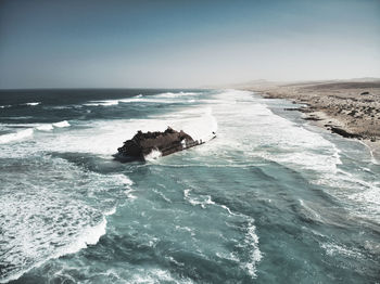 View of horse in sea against sky