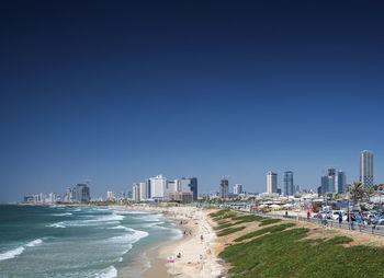 Panoramic view of beach and buildings against clear sky