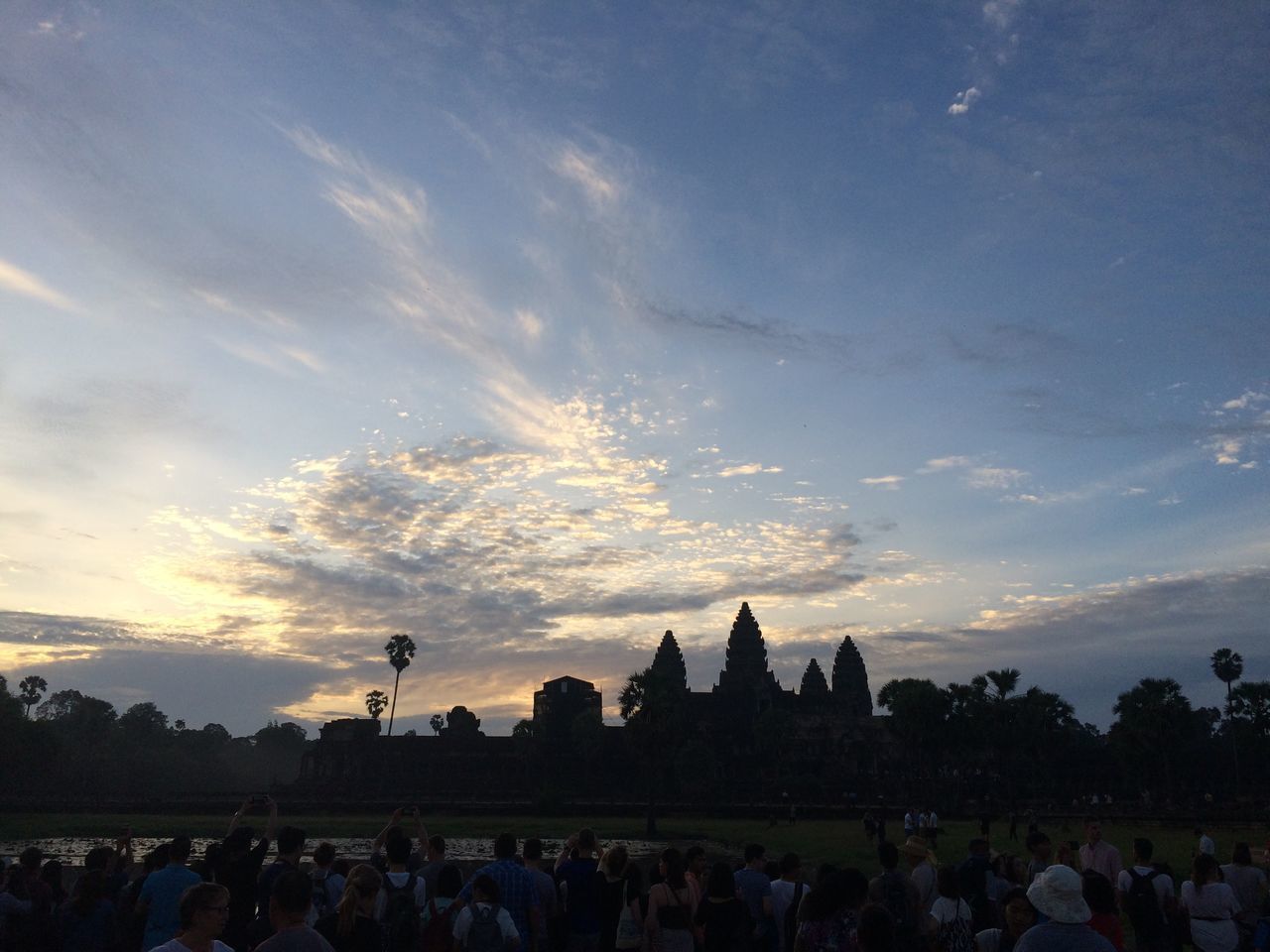 PEOPLE AT TEMPLE AGAINST SKY