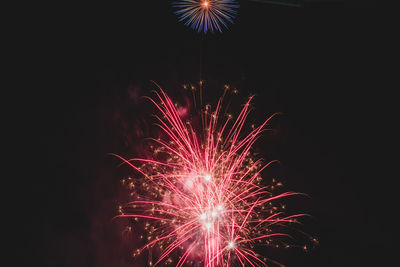 Low angle view of firework display at night