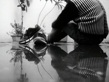 Close-up of woman with reflection in water