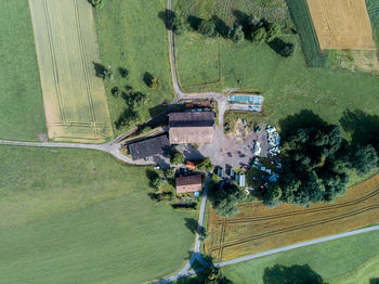 Aerial view of houses amidst field