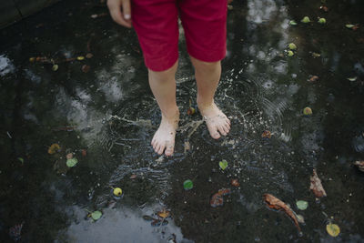 Boy's feet in a puddle