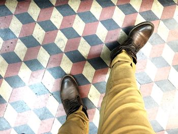 Low section of woman standing on tiled floor