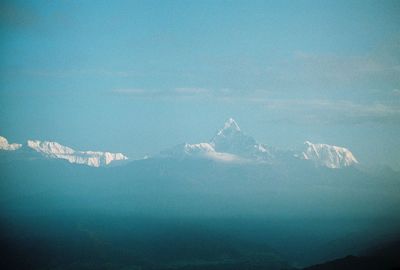Aerial view of mountains against blue sky