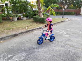 Full length of woman riding bicycle