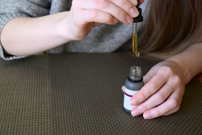 Cropped hand of woman holding electronic cigarette