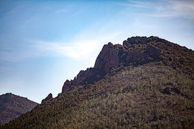 Low angle view of rock formations against sky