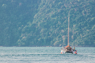 Sailboat sailing on sea against sky