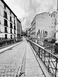 Street amidst buildings in city against sky