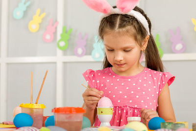 Portrait of cute girl playing with toys