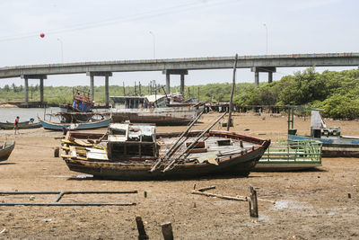 Boats moored on river against sky