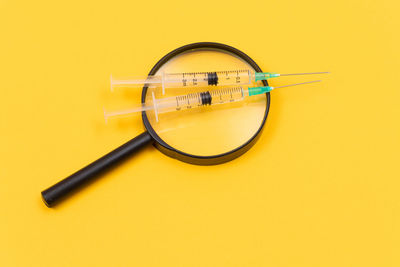 Close-up of wheel against yellow background