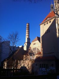 Low angle view of building against clear blue sky