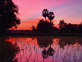 Scenic view of lake against romantic sky at sunset