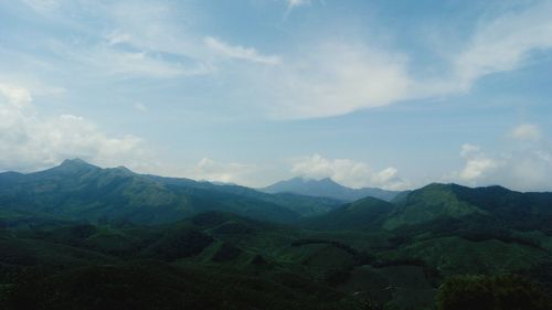 Scenic view of mountains against cloudy sky