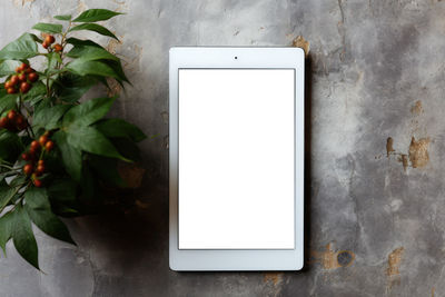 Directly above shot of digital tablet on wall