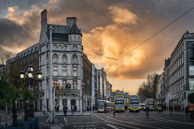 Early morning, sunrise, on busy oconnell bridge with luas and bus, dublin, ireland