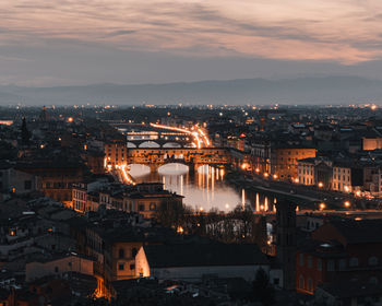 High angle view of illuminated buildings against sky at sunset